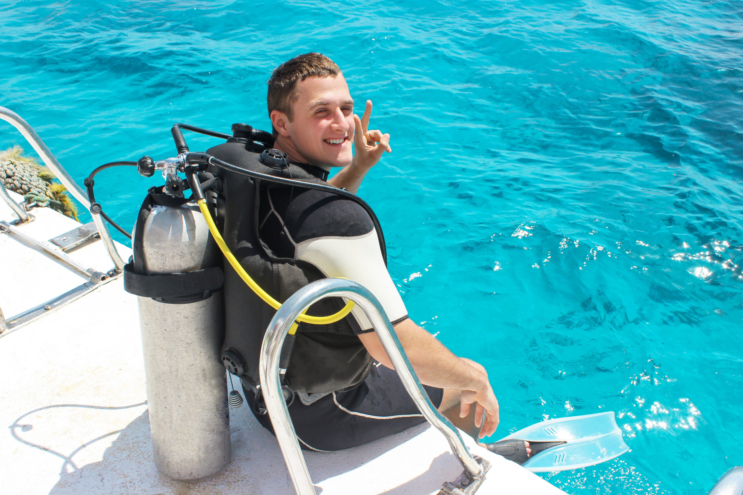 A scuba diver before diving. guy in diving outfit preparing to dive into the ocean