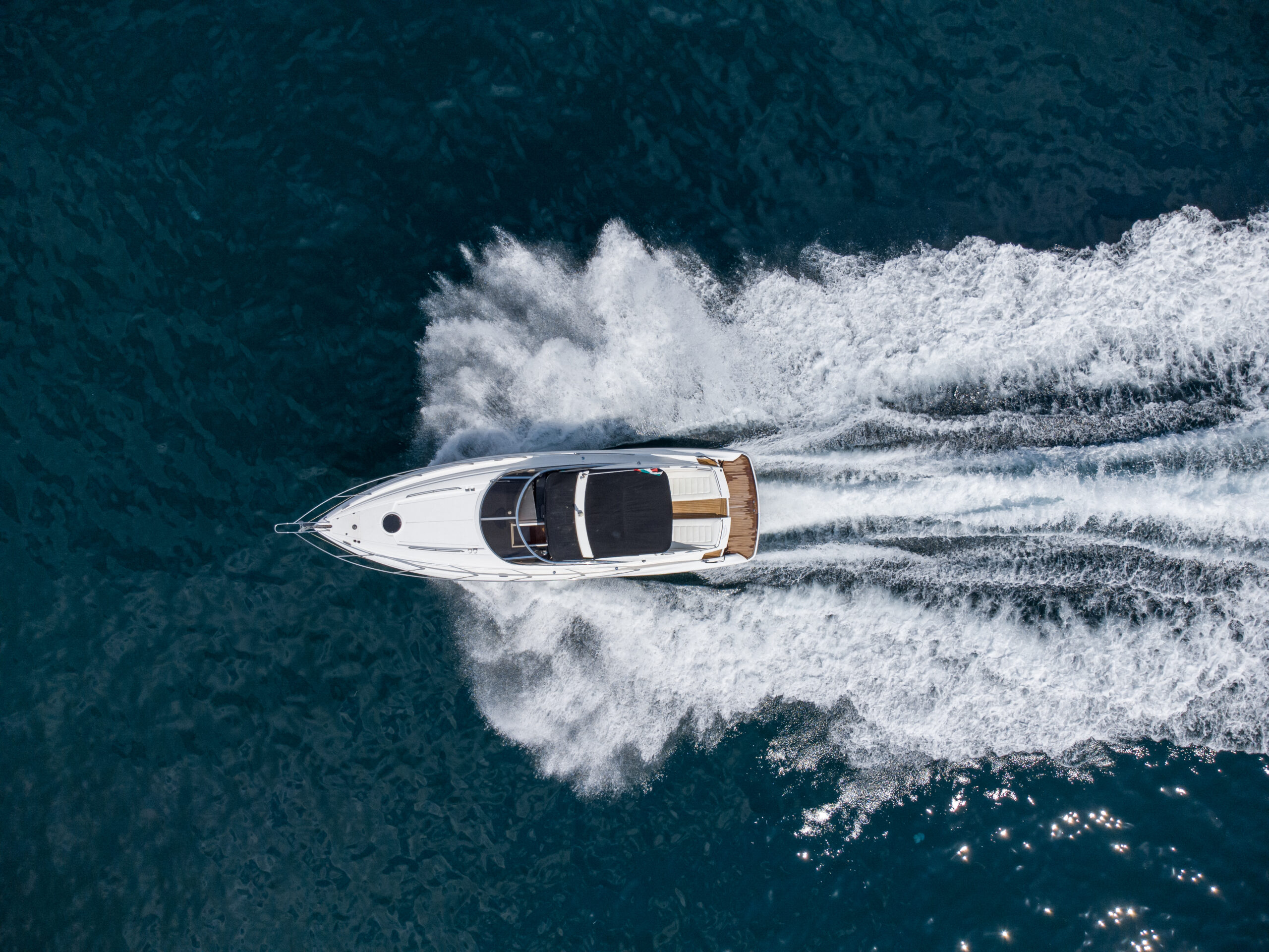 Aerial view of speed motor boat on open blue sea
