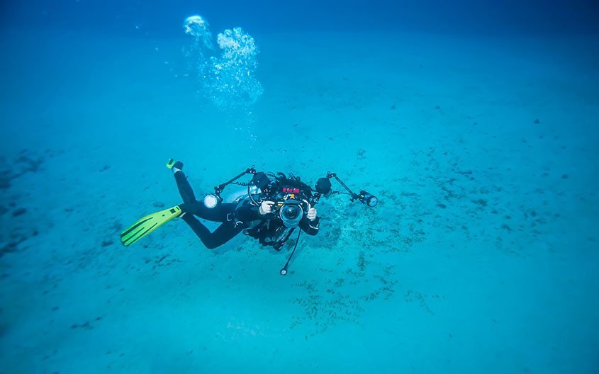 scuba-diver-swimming-underwater-with-a-camera-2026-01-11-10-34-13-utc